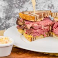 Corned Beef Ding · Hot corned beef sandwich ding size or Seattle style half the meat. Garnished with mustard, R...