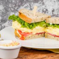 Organic Egg Salad · A vegetarian sandwich served with coleslaw and sliced pickles. Garnished with sliced heirloo...