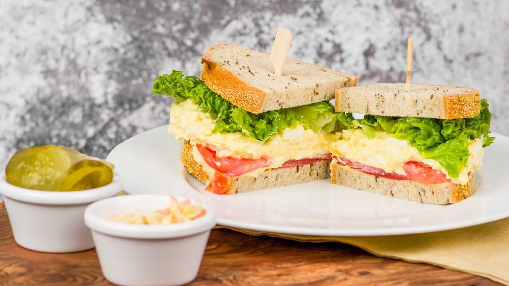 Organic Egg Salad · A vegetarian sandwich served with coleslaw and sliced pickles. Garnished with sliced heirloom tomato and lettuce. Pickles and coleslaw on side. Sub potato salad for an additional charge. Rye, marble rye, gluten free, or sub a bagel for an additional charge.