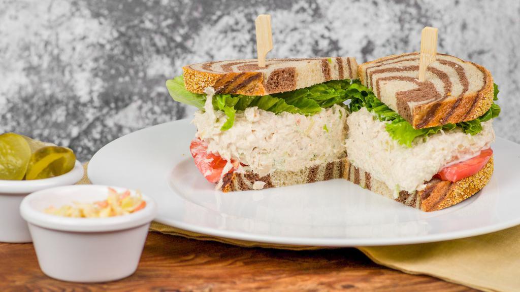 Tuna Salad · Albacore tuna salad sandwich served with lettuce and heirloom tomato. Pickles and coleslaw side. Sub potato salad for an additional charge. Rye, marble rye, gluten free, or sub a bagel for an additional charge.