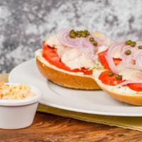 Bagel With Whitefish Salad & Schmear · Whitefish salad on a bagel of your choice served open-faced with capers, heirloom tomatoes, ...