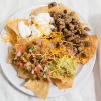 Super Nachos · Corn tortilla chips topped with carne asada, guacamole, pico de gallo, beans, sour cream, an...
