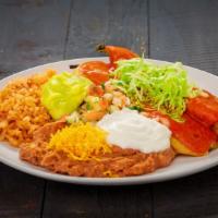 Chile Rellenos  · battered California peppers stuffed with white cheese. Served with rice and beans.