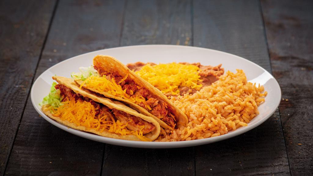 Two Chicken Tacos · Two red chicken tacos. Served with rice and beans.