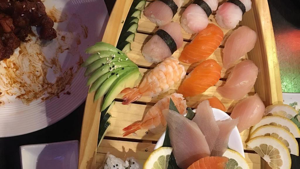 Love Boat · 9 pieces of sashimi, 12 pieces of nigiri, California roll, spicy tuna roll and salad.