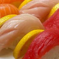 Nigiri Trio · 3 pcs Tuna, 3 pcs Salmon, 3 pcs Yellowtail.