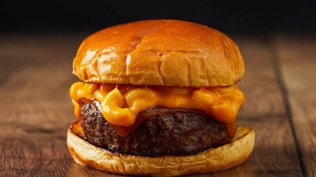 The Mac Burger · Beef patty, melted cheddar cheese, and macaroni and cheese on a brioche bun.