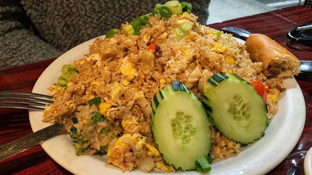 Crab Fried Rice · wok fried rice with crab meat, eggs,tomatoes, onions, peas, broccoli 
cucumber .