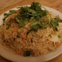 Garlic Fried Rice · Rice sautéed with garlic, white onion, peas, and carrots. Served with fresh cilantros on top.