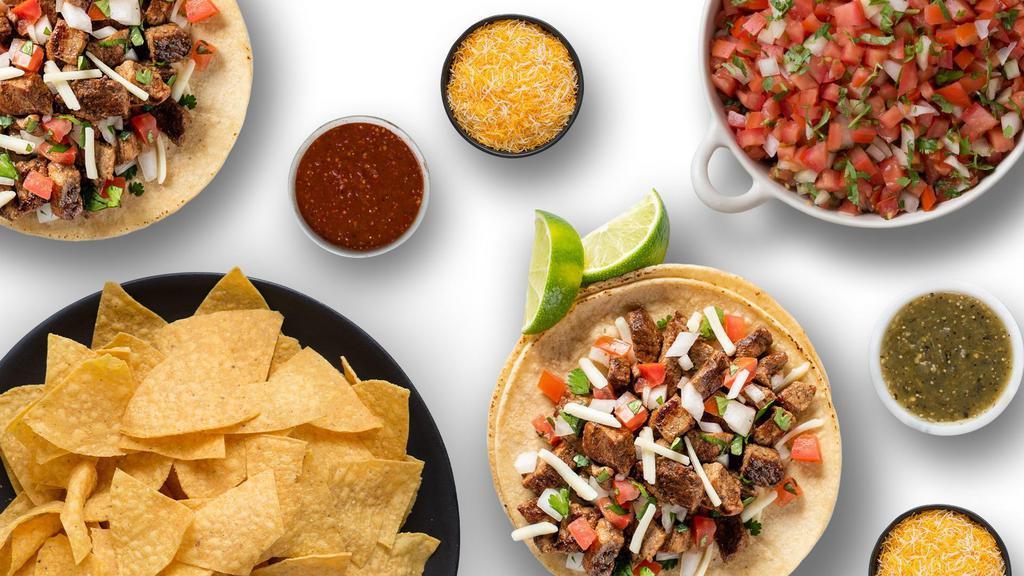 Family Taco Kit (Feeds 4) · Taco Bar for 4 - Comes with Choice of Two Proteins, Rice, Beans, Tortillas, Cheese, Cilantro, Onion, Limes, Lettuce, Tortilla Chips, Pico de Gallo, Salsa Roja and Salsa Verde. Add on sides: Guacamole, Queso, or Churro Bites, for dessert!