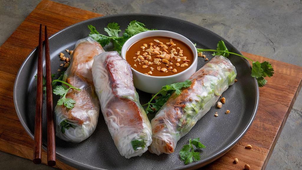 Pork Springrolls · Two rolls with braised pork belly, vermicelli noodles, shredded romaine lettuce mix, mint, bean sprouts, cilantro, served with peanut sauce. No substitutions at this time.