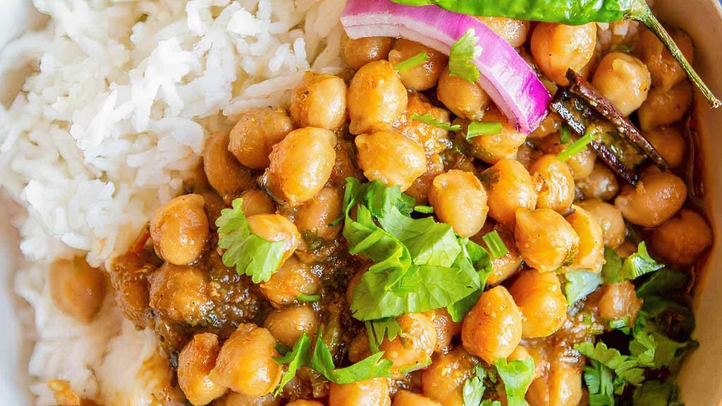 Chole Masala Curry Bowl · Stewed chickpeas and potatoes in our house curry sauce with spices. Served with basmati rice & naan.