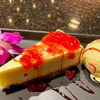 New York Cheesecake With Ice Cream · New York cheesecake with two scoops of vanilla bean ice cream. Topped with strawberry jam an...