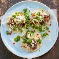 Beef Chiquito Tacos · Three slow-cooked beef tacos, shredded cabbage, feta & cilantro.
