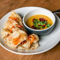 Hand-Made Roti & Curry · Buttery roti with coconut curry sauce for dipping