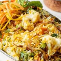 Vegetable Biryani · (GF) Hearty vegetables/meat and rice casseroles cooked with flavorful herbs & spices. Served...