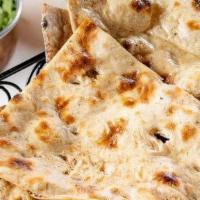 Tandoori Roti · Traditional flat breads cooked in our tandoor clay oven