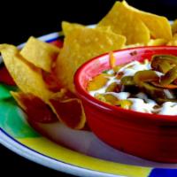 Azteca Queso Dip · Gluten free. Dip into a warm blend of selected cheeses, spinach and chiles. All baked togeth...