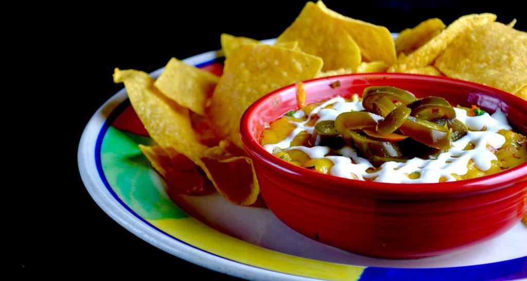 Azteca Queso Dip · Gluten free. Dip into a warm blend of selected cheeses, spinach and chiles. All baked together and served with fresh tortilla chips.