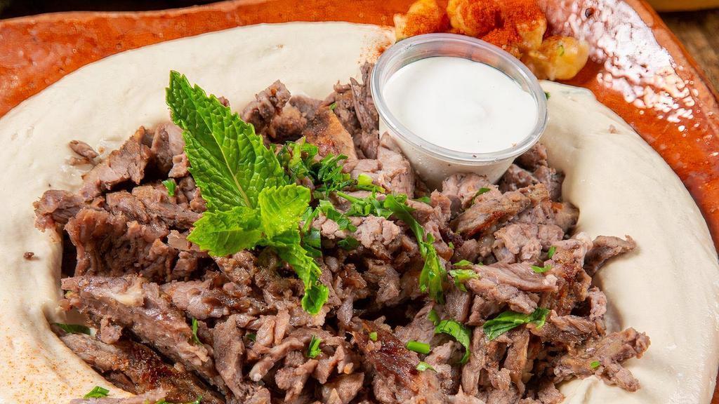 Hummus With Meat حمص مع لحمة · Hummus dip, topped with (lamb shawarma) and crispy pine nuts.