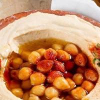 Hummus حمص · A creamy dip of chickpeas, tahini, lemon and garlic. Topped with olive oil.