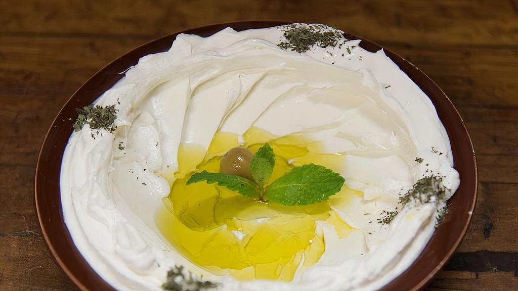 Tzatziki لبن مع خيار · Chopped cucumber and yogurt, seasoned with garlic and dried mint.