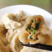 Steamed Gyoza (8) · Japanese dumplings filled with chicken and vegetables, served either steamed.