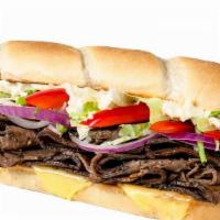 Unreal Gourmet Steak · Unreal steak slices, (v) Provolone, (v)Garlic mayo, roasted red peppers, red onions and lett...