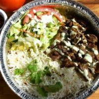 Beef Tikka Plate · Marinated beef pieces with a side of rice and salad.