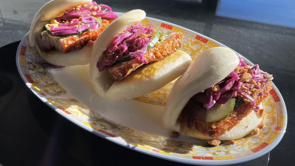 Pork Belly Buns · Three (3) folded steamed buns filled with slices of our crispy pork belly, pickles, red cabbage, ground peanuts and hot Chinese mustard.