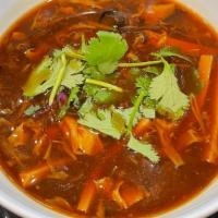 Hot And Sour Soup · Hot and sour soup, with bamboo shoots, shiitake mushrooms, tofu, and shredded chicken, for t...