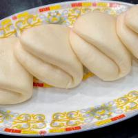 Steamed Buns · Four folded steamed buns, ideal for accompanying our BBQ meats.