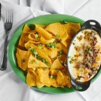 Queso Skillet · House specialty with melted pepperjack cheese and diced onions.