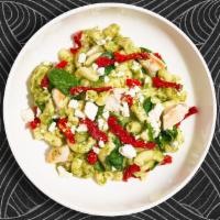 Pesto Manifesto Mac · Made with tender chicken, creamy pesto, sun-dried tomatoes, and spinach cooked in a blend of...