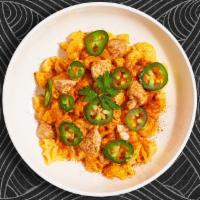 Flared Up Chicken Mac · An exciting combination of spicy roasted chicken, chipotle cheese sauce, and jalapenos cooke...