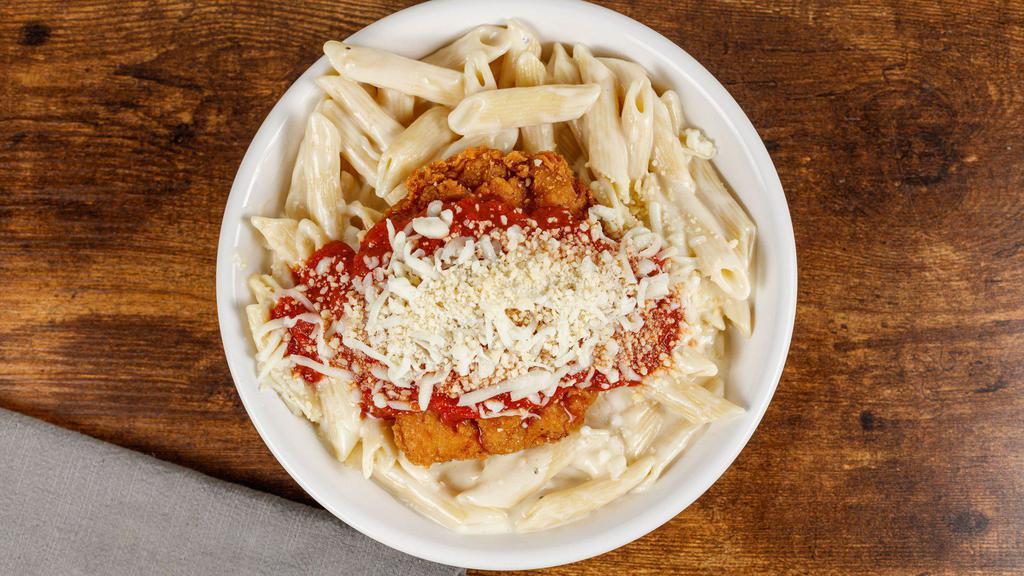 Chicken Parm Pasta · Crispy chicken tossed in our classic marinara with mozzarella cheese on a bed of penne alfredo pasta.  Served with a pretzel bread stick.