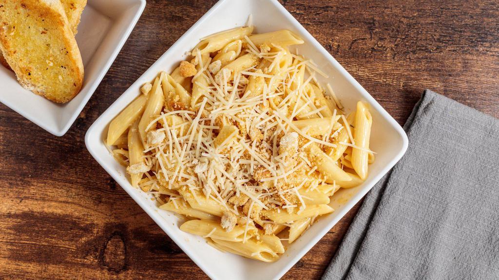 Baked Mac Mac · Penne pasta tossed in a creamy cheese sauce finished with toasted breadcrumbs and parmesan cheese.  Served with a pretzel bread stick.