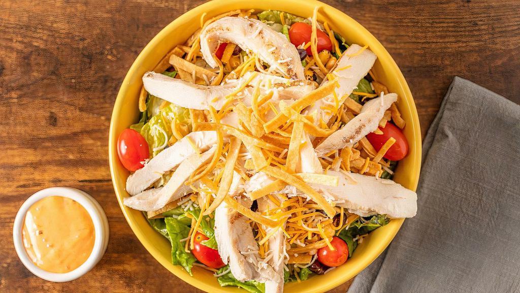 Southwest Chicken Salad · Romaine, grilled chicken, shredded mixed cheese, black beans & roasted corn, black olives, grape tomatoes, and tortilla strips. Try it with chipotle ranch dressing.
