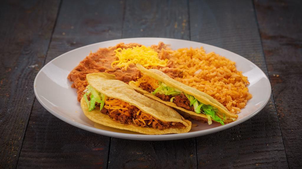 Beef Tacos (2) · Two shredded beef tacos. Served with rice and beans.