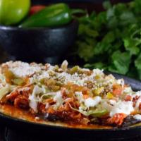 Huarache Asada (Handmade Of Corn And  Shaped Like A Mexican Sandal) · Huarache: spread with black beans topped with Asada, cabbage, sour cream and cotija cheese.
...
