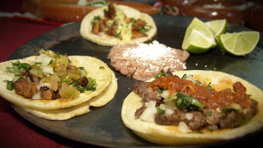 3  Street Taco Plate · Three tacos:  Asada/ Grilled Chicken/ Pastor / topped with onions cilantro and served with  rice and beans. 
( 3 Tacos seleccion: Asada / Pollo Marinado / Pastor con cebolla y cilantro).