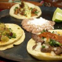 2 Street Taco Plate · Two tacos: Asada / Grilled Chicken/ Pastor / topped with onions and cilantro served with ric...