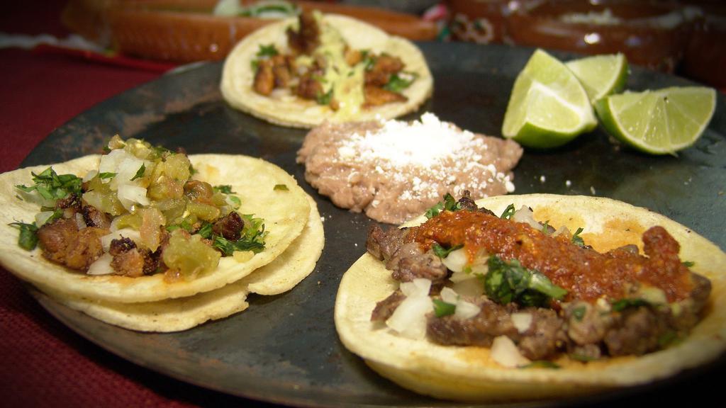 2 Street Taco Plate · Two tacos: Asada / Grilled Chicken/ Pastor / topped with onions and cilantro served with rice and beans. 
(2 Tacos seleccion de: Asada/ Pollo Marinado / Pastor con cebolla y cilantro).