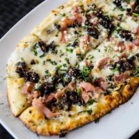Fig And Proscuitto Flat · Gorgonzola, black Mission figs, black pepper, prosciutto, chives.