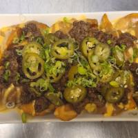 Junkyard Fries · Steak fries with bulgogi gravy, house made beer cheese topped off with bulgogi, green onions...