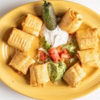 Chicken Taquitos · Mini rolled flour tortilla filled with chicken and cheese, served with guacamole and sour cr...