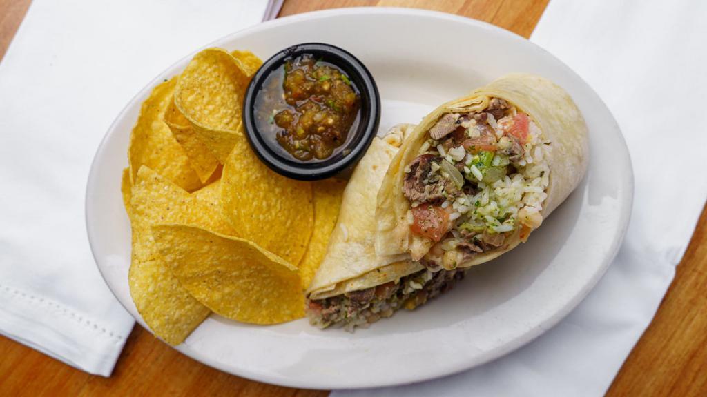 Grilled Steak Burrito · Grilled steak, whole white beans, jack cheese, pico de gallo, crema de chipotle & tacqueria guacamole. Comes with a handful of chips and a side of salsa
