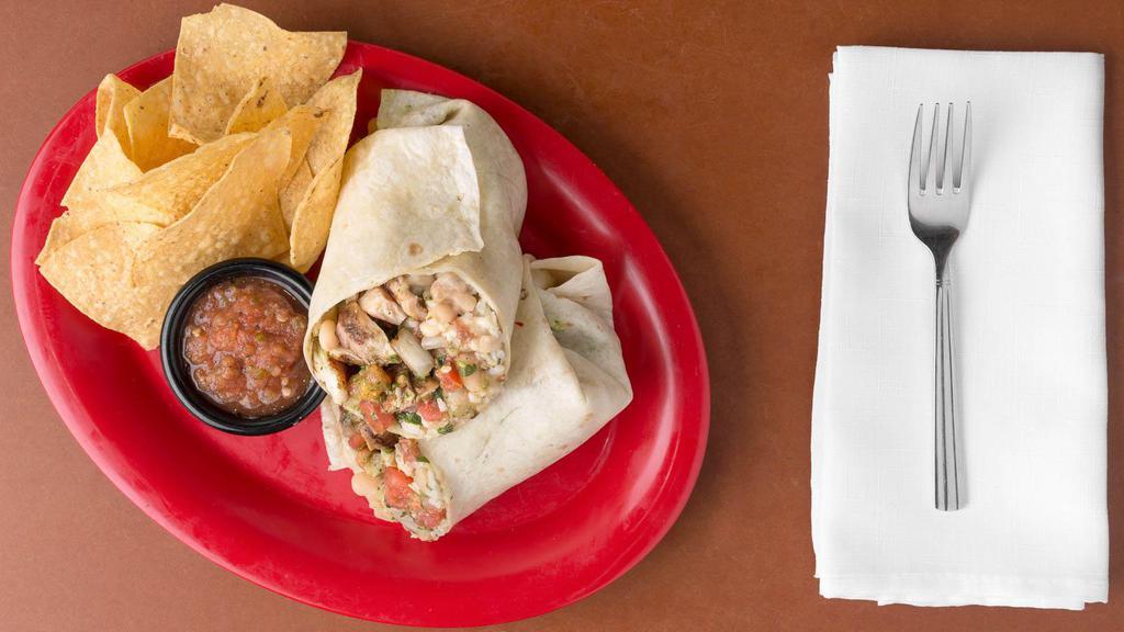 Grilled Chicken Burrito · Grilled chicken, whole white beans, minted rice, Jack cheese, pico de gallo, crema de chipotle and taqueria guacamole. Served with a handful of chips and a side of salsa.
