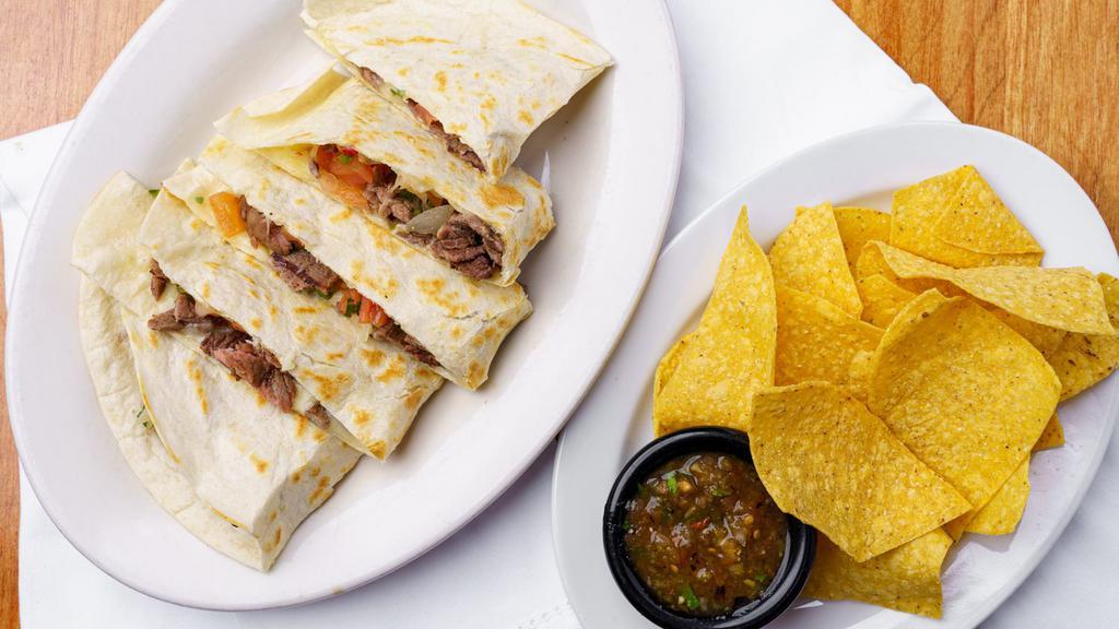 Grilled Steak Quesadilla · Grilled steak , melted jack cheese  and pico de gallo.  Served with a handful of chips and a side of salsa