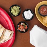 Chipotle Pork Quesadilla · Grilled pork, chunky guacamole, chipotle sour cream, melted Jack cheese, pico de gallo and c...